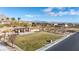 Community park area with a covered picnic area, lush green grass, and desert landscaping at 12169 Castilla Rain Ave, Las Vegas, NV 89138