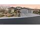 Charming home with a three-car garage, desert landscaping, and brick accents at 12169 Castilla Rain Ave, Las Vegas, NV 89138