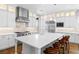 Gourmet kitchen with stainless appliances, a large island and custom white cabinetry at 12169 Castilla Rain Ave, Las Vegas, NV 89138