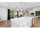 Kitchen with a large center island, white cabinets, modern lighting, and an open floor plan at 12169 Castilla Rain Ave, Las Vegas, NV 89138
