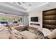 Comfortable living room with a modern fireplace, large sliding glass doors, and stylish decor at 12169 Castilla Rain Ave, Las Vegas, NV 89138