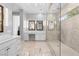 Main bathroom featuring double sinks, a makeup vanity, and an oversized shower with mosaic tile at 12169 Castilla Rain Ave, Las Vegas, NV 89138