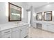 Main bathroom featuring double sinks, a makeup vanity, and large decorative mirrors with sconce lighting at 12169 Castilla Rain Ave, Las Vegas, NV 89138