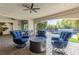 Elegant covered patio with comfortable seating and a fire pit, perfect for enjoying the outdoors year-round at 12169 Castilla Rain Ave, Las Vegas, NV 89138
