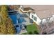 Aerial view of backyard featuring a large pool, spa, patio area, and artificial grass at 12169 Castilla Rain Ave, Las Vegas, NV 89138