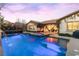 The sparkling pool and spa are illuminated at twilight, creating a luxurious ambiance at 12169 Castilla Rain Ave, Las Vegas, NV 89138