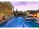 Beautiful backyard pool and spa with stone waterfall feature, landscaping, and mountain views at 12169 Castilla Rain Ave, Las Vegas, NV 89138