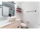 Bright bathroom with a contemporary vanity and bowl sink, floating shelves for decor, and sleek fixtures for a modern look at 1408 E Carson Ave, Las Vegas, NV 89101