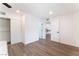 Spacious bedroom with wood floors, closet space, and doorway leading to kitchen area at 1408 E Carson Ave, Las Vegas, NV 89101