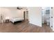 Light-filled bedroom with a queen bed, ceiling fan, closet space, and an attached bathroom at 1408 E Carson Ave, Las Vegas, NV 89101
