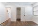 Bedroom with wood-look flooring, with closet and open doorway, provides a blend of style and functionality at 1408 E Carson Ave, Las Vegas, NV 89101