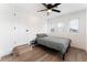 Cozy bedroom with wood-look floors, ceiling fan, and windows, providing a comfortable and inviting space at 1408 E Carson Ave, Las Vegas, NV 89101