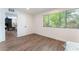 Bedroom with wood floors, large window, and view to living room at 1408 E Carson Ave, Las Vegas, NV 89101