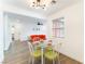 Bright dining area features a glass table set for four with an open-concept to a living area with wood floors at 1408 E Carson Ave, Las Vegas, NV 89101