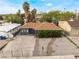 Exterior view of home with fenced yard, desert landscaping, front driveway and sidewalk access at 1408 E Carson Ave, Las Vegas, NV 89101
