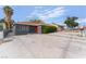 Charming single-story home with a well-maintained front yard and a vibrant red front door at 1408 E Carson Ave, Las Vegas, NV 89101