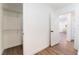 View of hallway with wood-look floors, an open closet, and a glimpse into a dining area, creating an inviting transition at 1408 E Carson Ave, Las Vegas, NV 89101