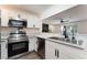 Modern kitchen featuring stainless steel appliances, white cabinets and granite countertops with a stainless steel sink at 1408 E Carson Ave, Las Vegas, NV 89101