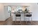 Open kitchen view with a bar and two stools, modern appliances, and a laundry room visible to the left at 1408 E Carson Ave, Las Vegas, NV 89101