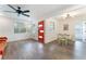 Bright and modern living area features hardwood floors, a vibrant red door, and an adjacent dining space at 1408 E Carson Ave, Las Vegas, NV 89101