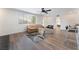Cozy living room with a neutral sofa, a modern rug, wood floors, and a view of the kitchen bar at 1408 E Carson Ave, Las Vegas, NV 89101