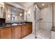 Modern bathroom featuring a vanity with a black countertop and a glass-enclosed shower at 145 E Harmon Ave # 201, Las Vegas, NV 89109