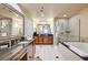 Spacious bathroom featuring a glass shower and a soaking tub at 145 E Harmon Ave # 201, Las Vegas, NV 89109
