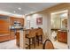 Modern kitchen features wood cabinetry, granite countertops, stainless steel appliances, and breakfast bar with seating at 145 E Harmon Ave # 201, Las Vegas, NV 89109