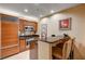Modern kitchen features wood cabinetry, granite countertops, stainless steel appliances, and breakfast bar seating at 145 E Harmon Ave # 201, Las Vegas, NV 89109