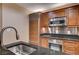 This kitchen has stainless steel appliances, sleek dark countertops, and rich wood cabinetry at 145 E Harmon Ave # 201, Las Vegas, NV 89109