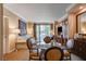 Living area featuring a dining table, sofa, balcony access, and TV at 145 E Harmon Ave # 201, Las Vegas, NV 89109