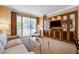 Bright living room featuring a sofa, armchair, balcony access, and an entertainment center at 145 E Harmon Ave # 201, Las Vegas, NV 89109
