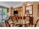 Cozy living area with a dining table, sofa, balcony access, and built-in wooden entertainment center at 145 E Harmon Ave # 201, Las Vegas, NV 89109