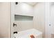 Clean bathroom with a modern tub, stylish tile accent and black shower fixtures at 1917 N Moapa Valley Blvd, Logandale, NV 89021