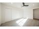Bright bedroom with a ceiling fan, large closet and plush carpeting at 1917 N Moapa Valley Blvd, Logandale, NV 89021