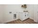 Well-lit laundry room with storage cabinets, countertop, and utility connections at 1917 N Moapa Valley Blvd, Logandale, NV 89021