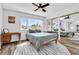 Bright bedroom featuring a bed, large windows offering ample natural light, and mirrored closet doors at 2021 N Michael Way, Las Vegas, NV 89108