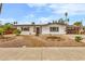 Charming single-story home with desert landscaping and a covered carport at 2021 N Michael Way, Las Vegas, NV 89108