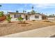 Inviting single-story home with rock landscaping, mature trees, and charming curb appeal at 2021 N Michael Way, Las Vegas, NV 89108