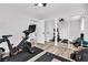 Spacious home gym equipped with exercise equipment, featuring sliding mirror doors and laminate floors at 2021 N Michael Way, Las Vegas, NV 89108