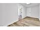 Hallway with wood floors leading to a bedroom with white doors and an open doorway at 2021 N Michael Way, Las Vegas, NV 89108