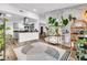 An open space featuring a kitchen with stainless steel appliances and a living area with stylish greenery at 2021 N Michael Way, Las Vegas, NV 89108