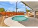 A backyard kidney-shaped pool surrounded by desert landscaping and a privacy fence at 2021 N Michael Way, Las Vegas, NV 89108