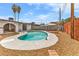 A beautiful backyard kidney-shaped pool with lounge area and desert landscaping at 2021 N Michael Way, Las Vegas, NV 89108