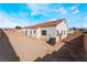 Expansive backyard with dirt landscaping, brick wall, and an AC unit, perfect for creating an outdoor living space at 2117 Mountain Sunset Ave, North Las Vegas, NV 89031