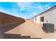 Spacious backyard with dirt landscaping, enclosed by a block wall, presenting a blank canvas for customization and outdoor enjoyment at 2117 Mountain Sunset Ave, North Las Vegas, NV 89031