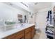 Bright bathroom featuring a large mirror and vanity with wooden cabinets at 2117 Mountain Sunset Ave, North Las Vegas, NV 89031