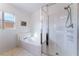 Bright bathroom featuring bathtub and glass-doored shower at 2117 Mountain Sunset Ave, North Las Vegas, NV 89031