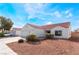 Inviting single-story home with a tile roof, complemented by manicured landscaping and ample parking space at 2117 Mountain Sunset Ave, North Las Vegas, NV 89031