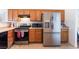 Kitchen featuring stainless steel appliances, wood cabinetry, and black hardware at 2117 Mountain Sunset Ave, North Las Vegas, NV 89031